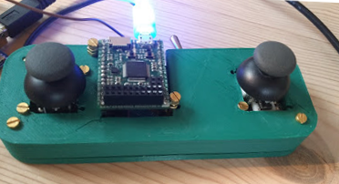 This is the controller for the ROV it's 3d printed, the PyBoard is clearly visible on the top, the two joysticks control movement and the switch lights.